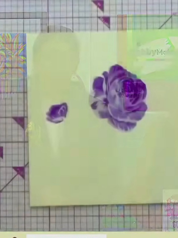 Step 7: Using the same layering stencil system, apply green colour to the leaves and stem area. Build up the colour gr