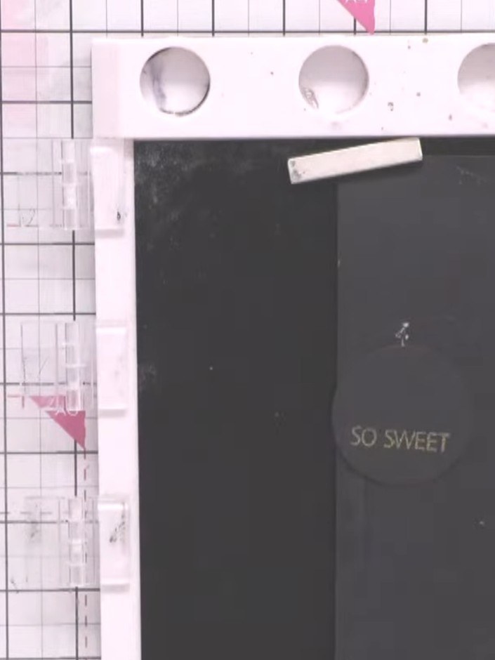 Step 7: Apply gold embossing powder to the stamped 'SO SWEET' sentiment on the black card. Heat with a heat gun until 
