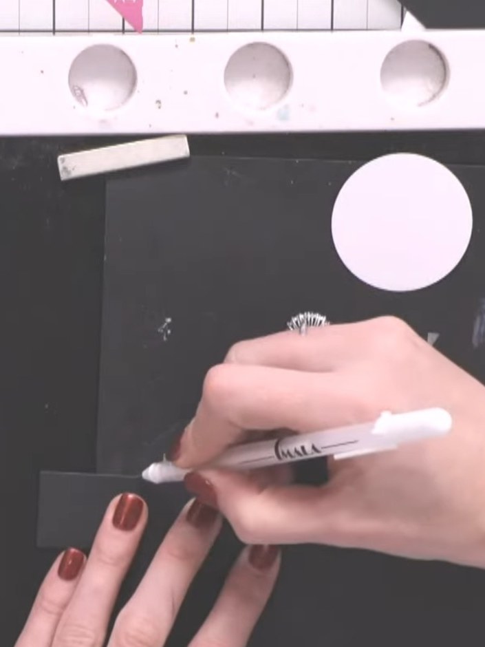 Step 9: Using a white ink pad and a spot brush, dab small white ink impressions around the stamped lady figures to cre
