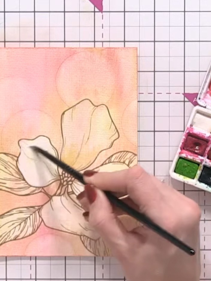 Step 10: Using a wet brush, drop brown-yellow watercolour onto the wet white petals to add warmth and detail to the flo