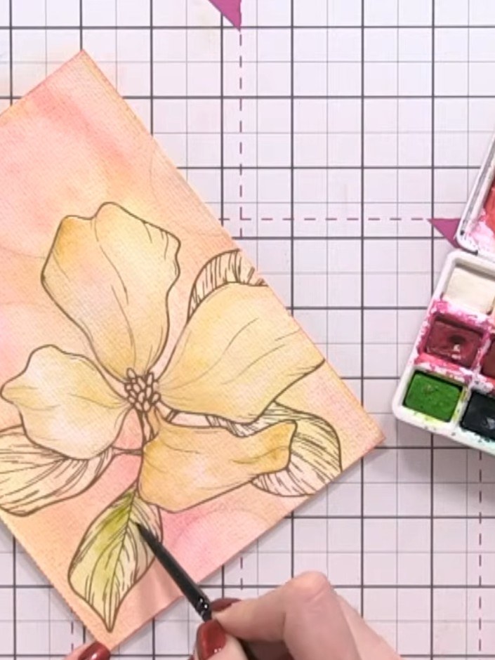 Step 11: Paint the leaves by first wetting them with clean water, then drop in green watercolour to create soft, natura