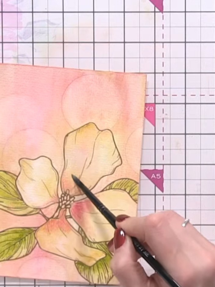 Step 12: Using a wet brush, pick up a touch of light pink watercolour and pounce it onto the wet flower centre area to 
