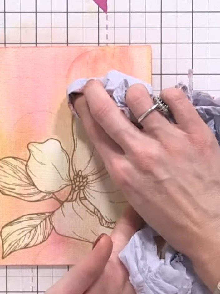 Step 8: Use a piece of tissue to gently lift and dab away colour from within the water-filled circles on the watercolo