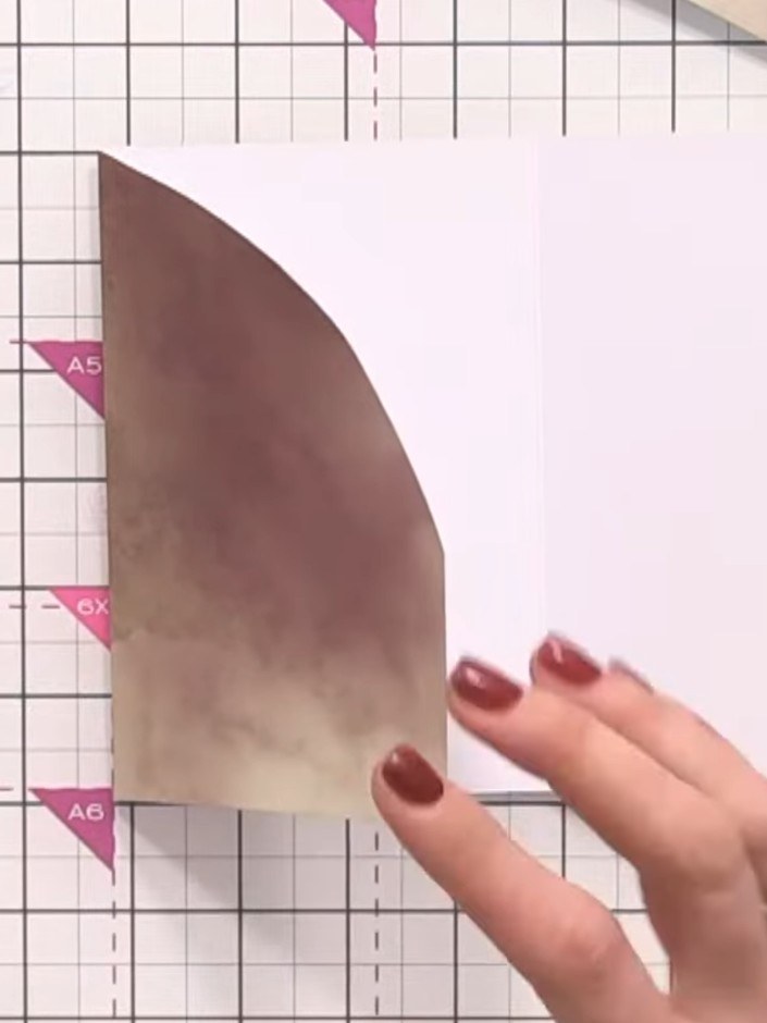 Step 7: Apply glue along the side and base edges of the arched pink section. Press the edges down to create a pocket, 