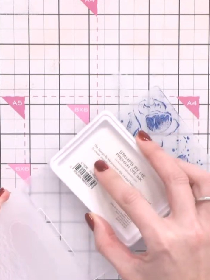 Step 10: If desired, gently blend the white ink with your fingertip to create a softer, more subtle effect on the embos