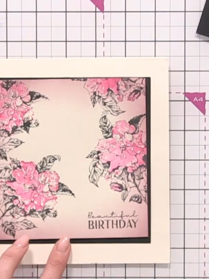 Step 11: Layer the decorated floral panel onto the black mat layer and attach it to the cream card base to complete you