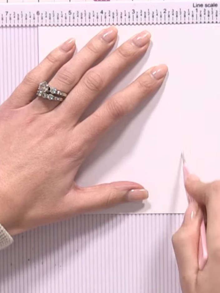 Step 3: Score the top flap at the 3-inch mark in the centre to create a fold line that divides it in half.