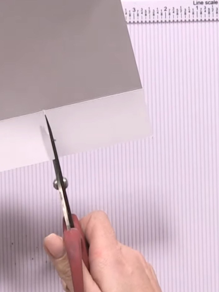 Step 4: Cut straight down the centre line from the top edge to the middle point of the white card.