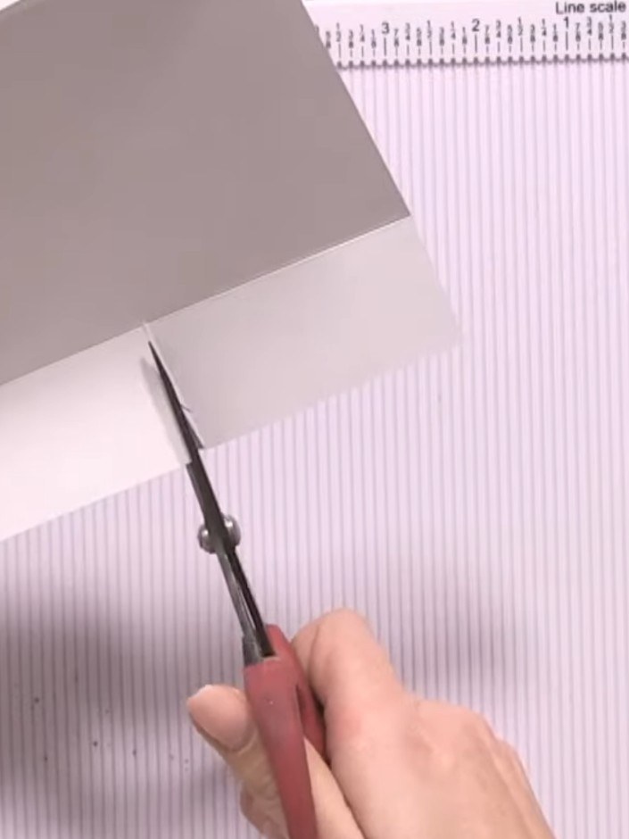Step 5: Trim away small triangular sections from the cut edges of the white card pieces to remove bulk and create neat