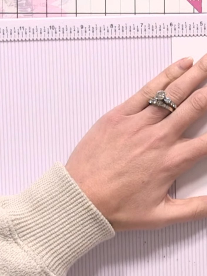 Step 1: Score a half-inch hinge along one edge of your 6x6 paper using your scoring board.