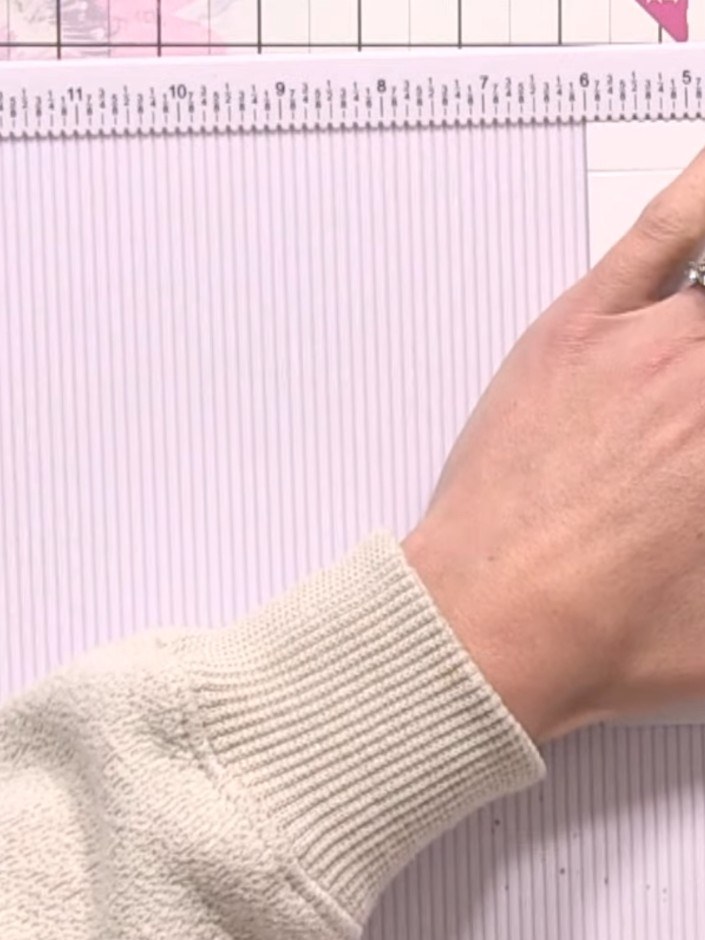 Step 2: Turn the paper 90 degrees. Score another half-inch line along the adjacent edge, maintaining the same distance