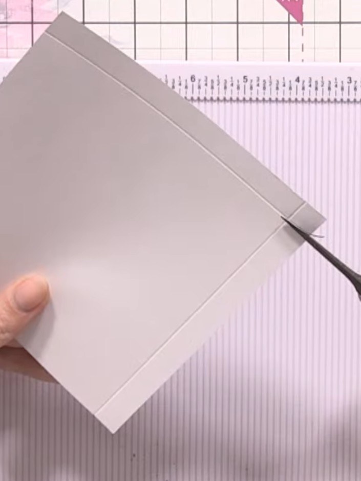 Step 4: Fold the bottom edge of the card up to meet the top edge, creating a pocket shape. Hold the card in place and 