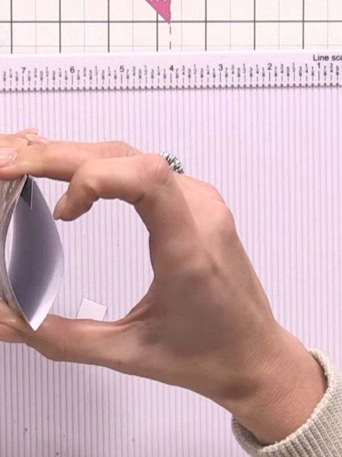 Step 8: Attach one tab punch to the front of the pocket and one to the back to create a pull-out closure. The tabs wil
