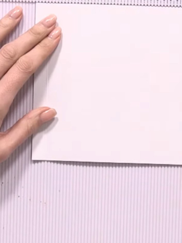 Step 2: Turn the white card base and score at the 2-inch mark to create the front pocket fold line.
