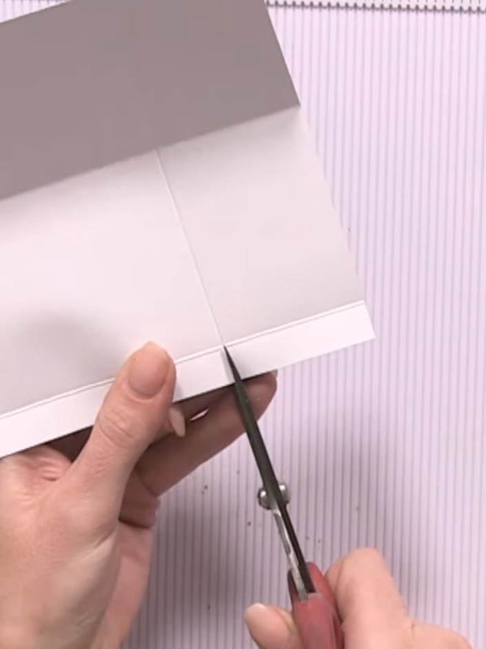 Step 8: On the back of the page, attach a strip of white offcut paper along the bottom edge using quarter-inch score l