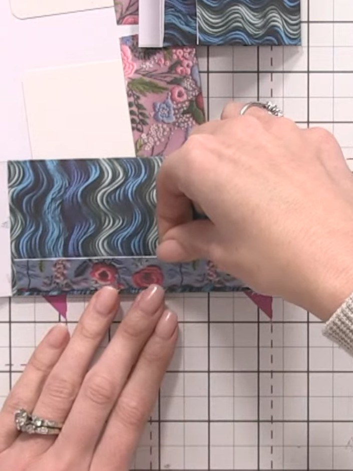 Step 7: Adhere the small pocket (with the blue wavy pattern) to the inside of your base pocket (with the floral patter