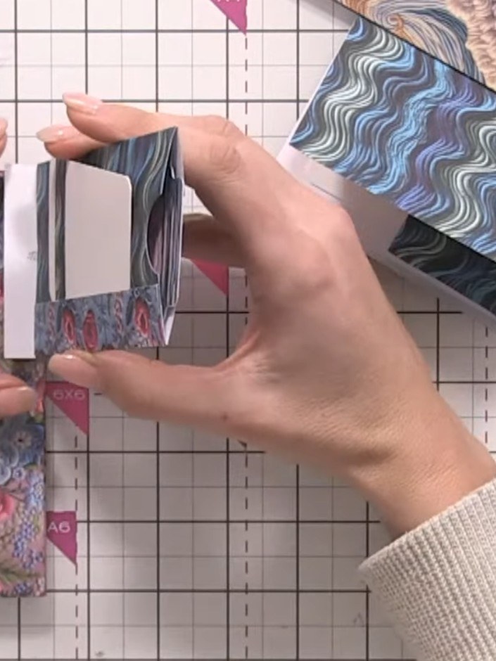 Step 1: Score a half-inch hinge along the top edge of your 6x6 patterned paper using a scoring tool.