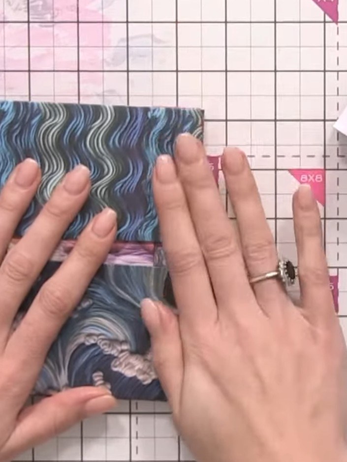 Step 3: Fold the wavy patterned paper along the scored lines to create the pocket structure between the two hinges. Pr