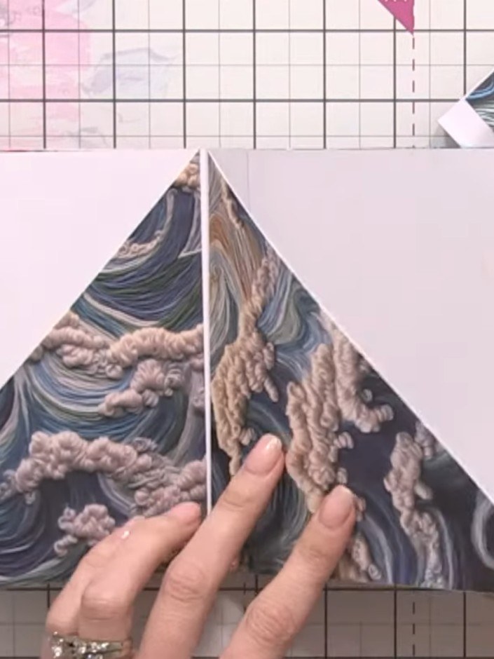 Step 4: Arrange your decorative paper pieces on the craft mat to check the design and ensure the patterns complement e