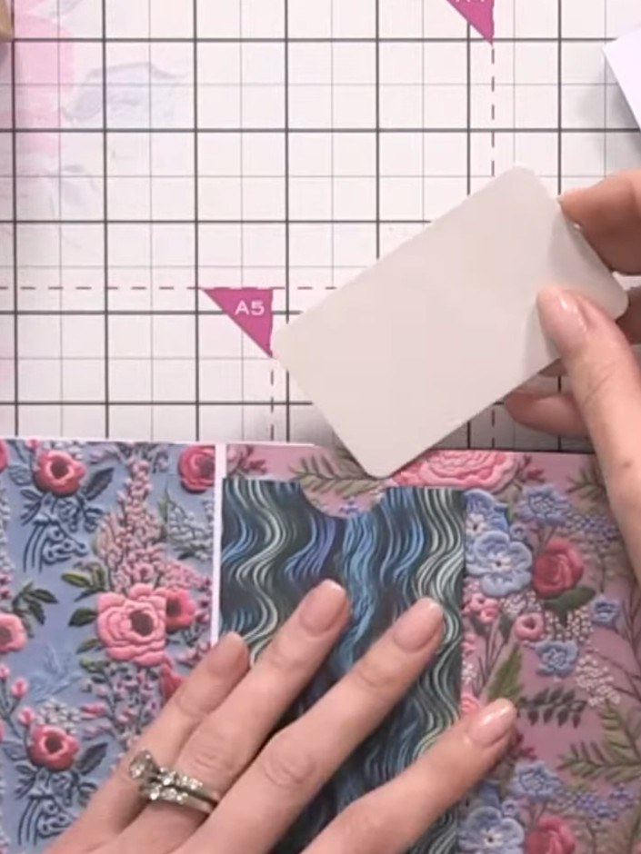 Step 6: Layer the small white card pieces inside and on top of your main patterned paper pocket to create layered pock