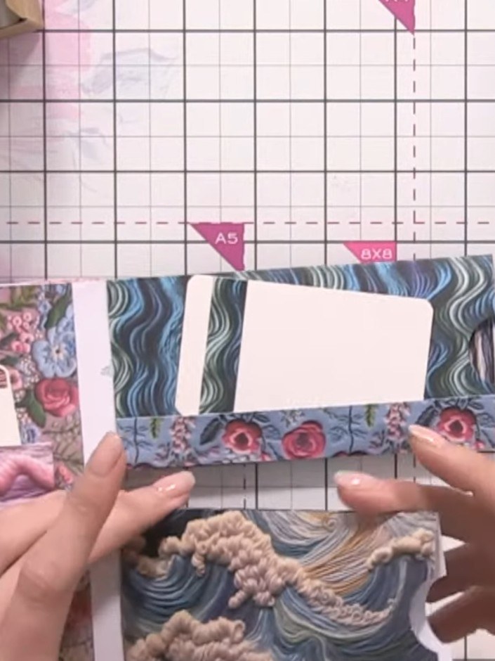 Step 7: Use your 1-inch circle punch to punch circular openings in the white panels of your pockets. Position the punc