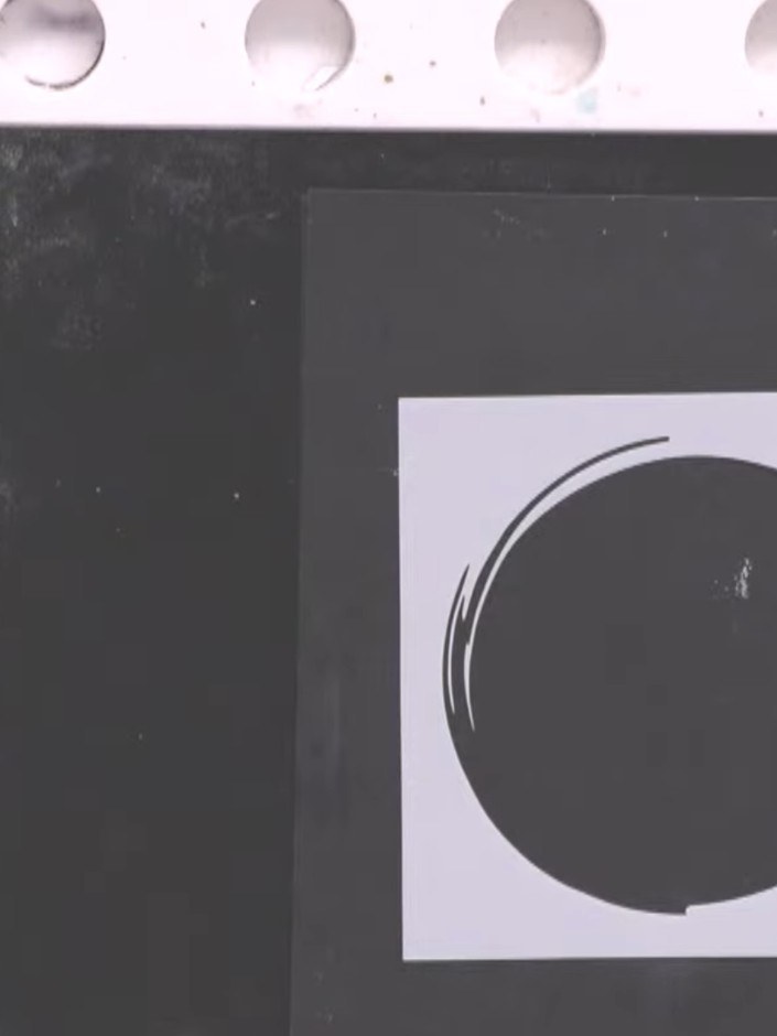 Step 2: Position the circle stencil high up in the centre of the white card panel.