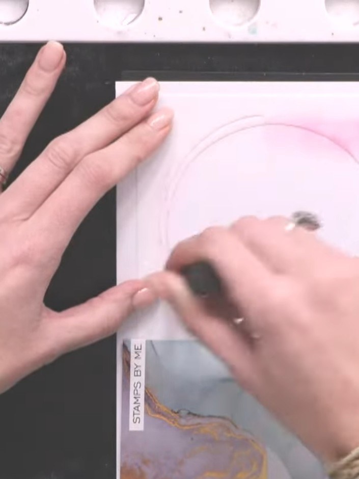 Step 4: Apply pink ink to a blending brush and dab the colour inside the stylized circle stencil, following the design