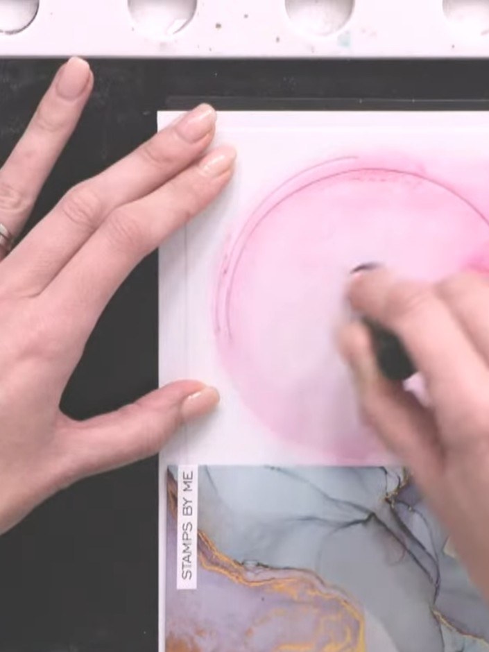 Step 5: Add touches of orange ink through the circle stencil in some areas, not covering the entire design. Use a blen