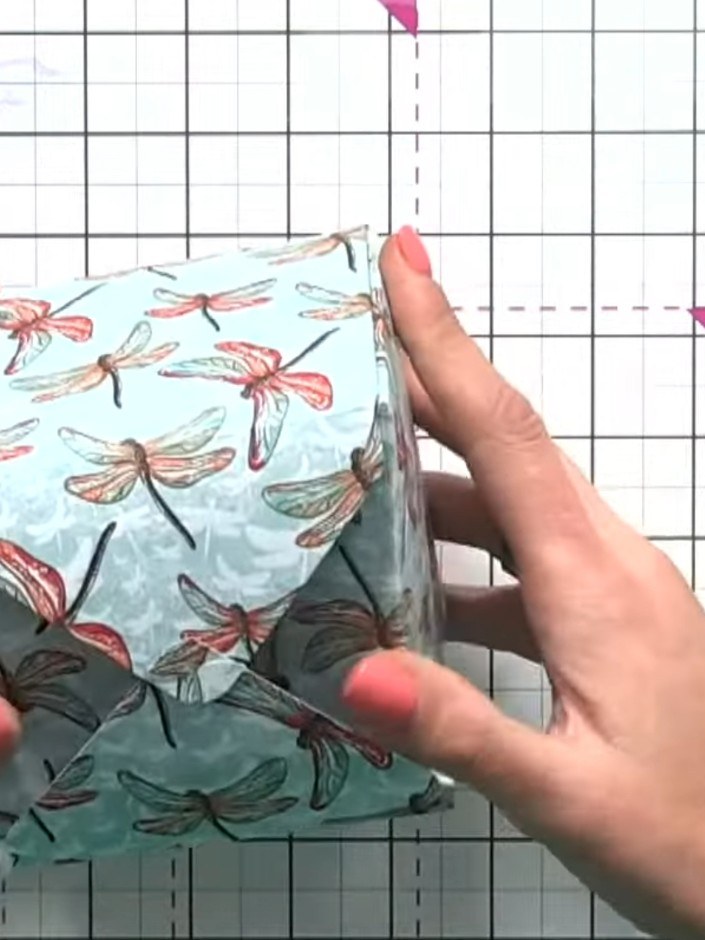 Step 13: Connect the hook-and-eye system at each corner by interlocking the punched features to secure the box. Give th