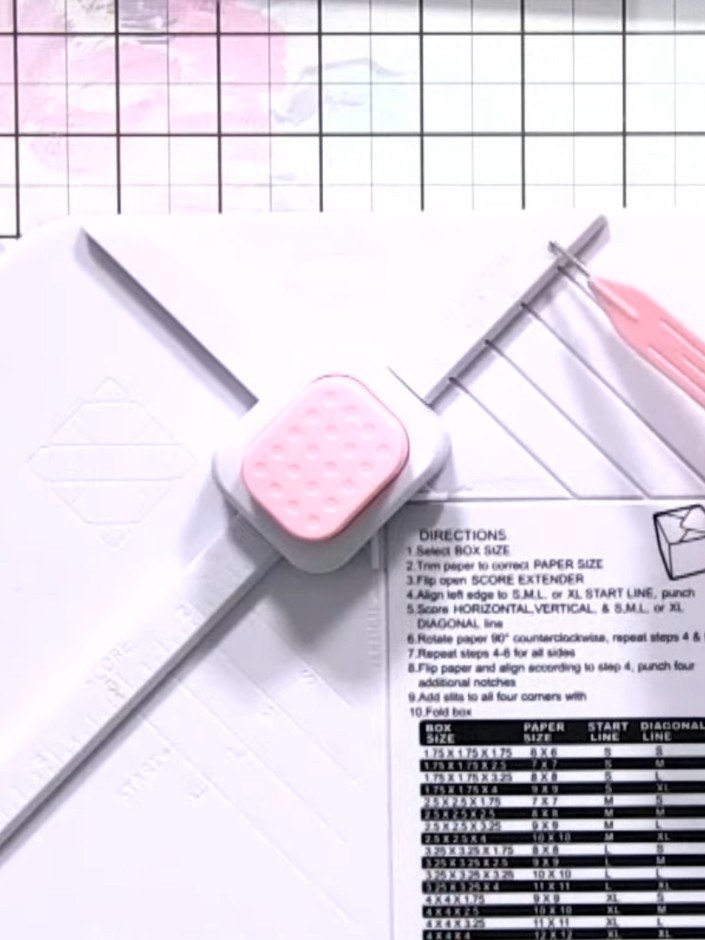 Step 2: Insert the paper into the box maker tool, aligning it with the XL start line on the diagonal scoring guide.