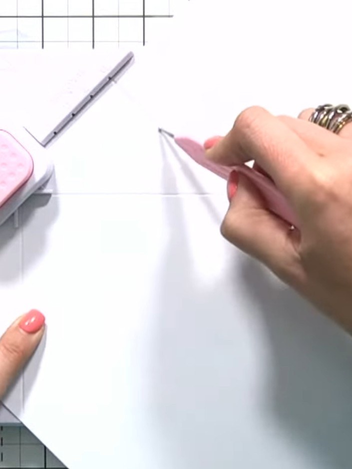 Step 4: Using the scoring tool, score along the entire length of the paper on the start line, working from top to bott
