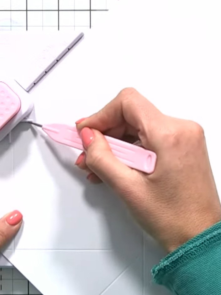 Step 6: Using the envelope and box tool, punch and score along the diagonal XL line on the pink cardstock. Turn the ca