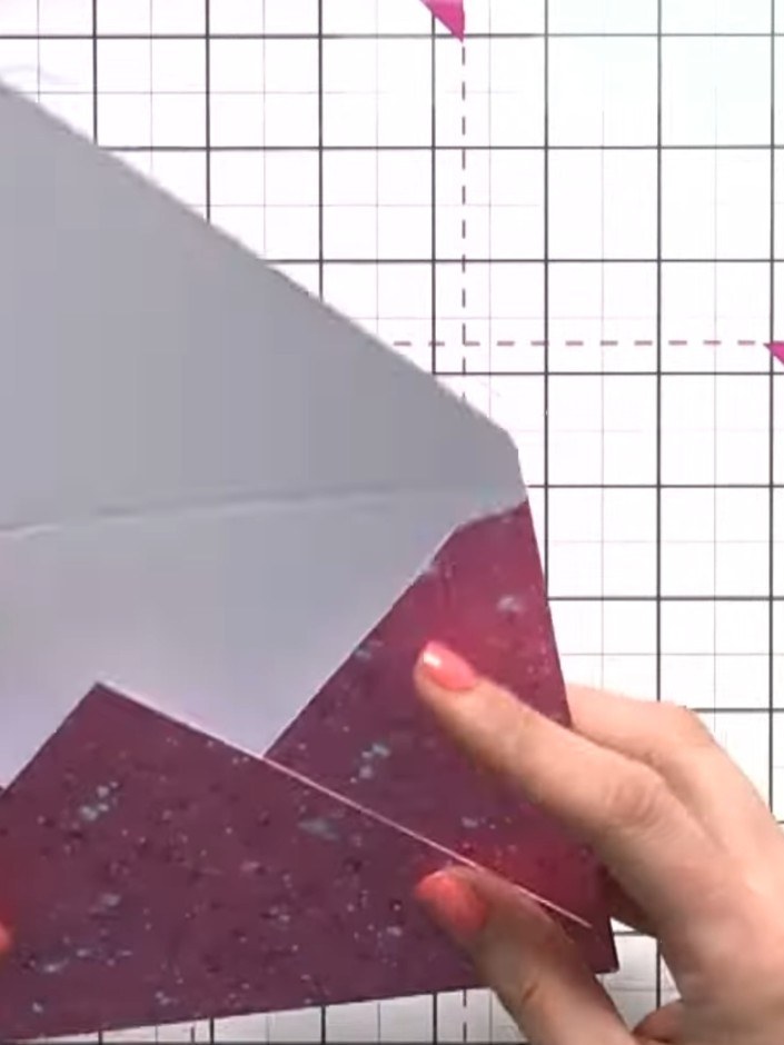 Step 8: Fold the envelope into shape by bringing the triangular flaps together. Layer the grey cardstock piece over th