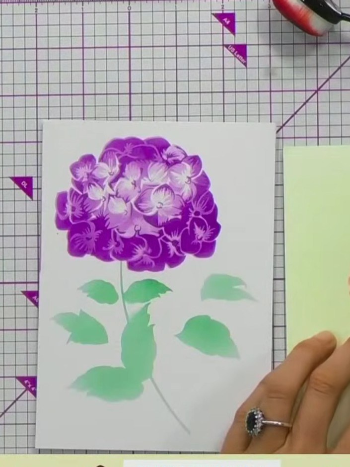 Step 8: Lightly spray the finished floral design with water to create a blended, watercolour effect. The water will so