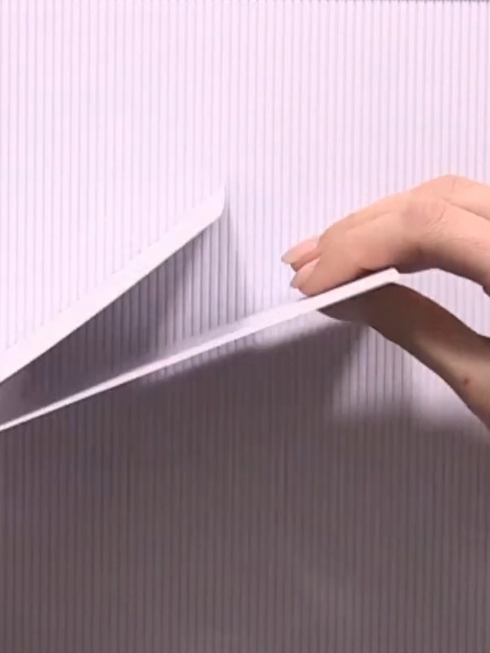 Step 4: Score a third sheet of paper at two inches. Glue this scored sheet onto the back of your front cover to create