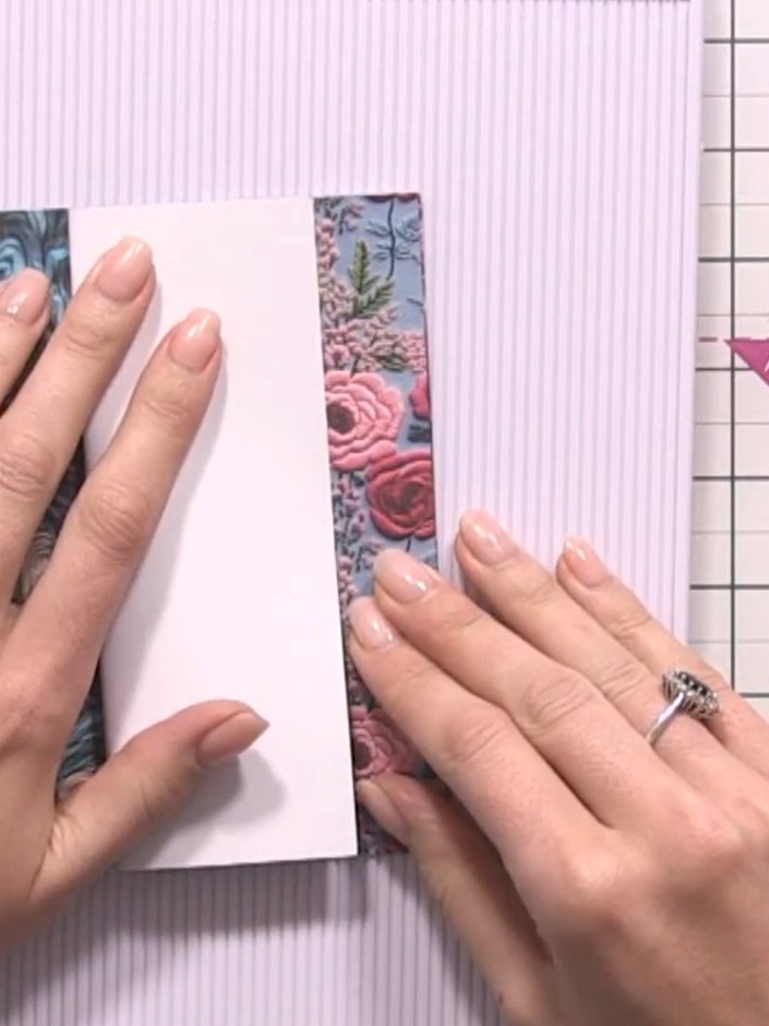 Step 6: Score a fifth sheet of patterned paper at half an inch to create another hinge for the back cover.