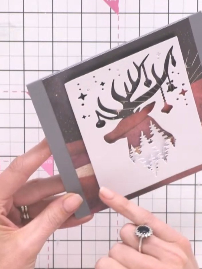 Step 10: Secure all layers together with tape or glue to ensure nothing shifts. Your finished layered stag and tree lin