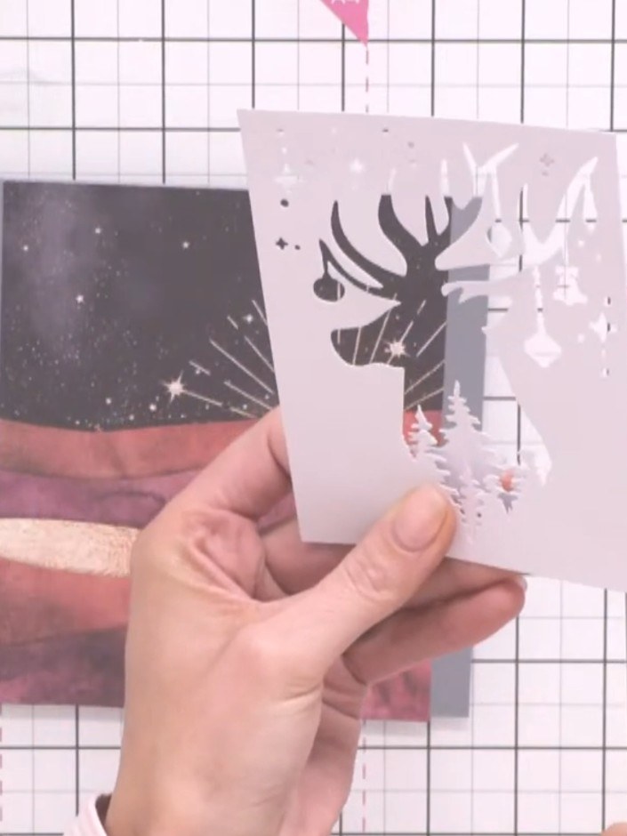 Step 6: Add a second tree line piece at a different height to the card front. Trim the excess from the leg of the stag