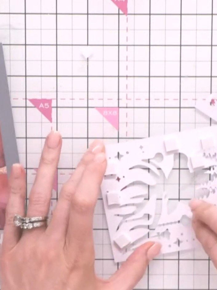 Step 8: Cut a pre-printed sentiment from the Merry & Bright collection. Adhere it below the tree line arrangement on y