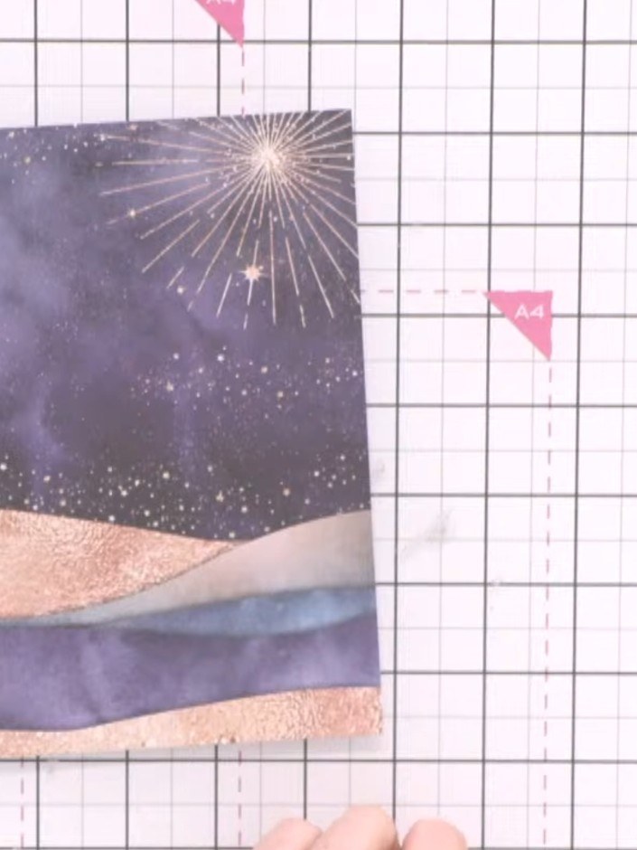 Step 1: Select a patterned paper from the Merry & Bright pad that features hill designs in purple and peach tones with