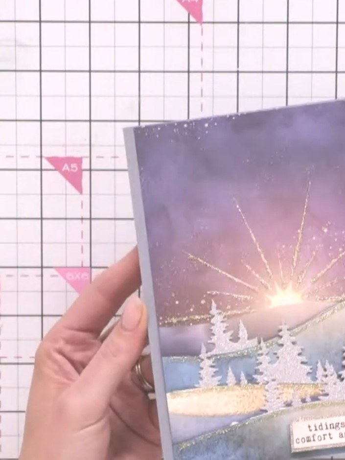 Step 10: Optional: Apply gold glitter glue along the cut edges of the hills to add sparkle and highlight the layered la