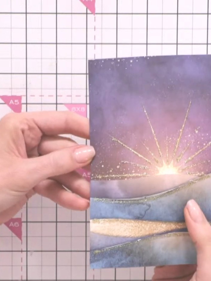 Step 4: Position the first tree line piece into one of the hill cutouts on your card base, ensuring it sits level and 