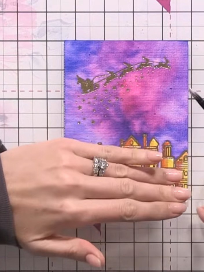 Step 10: Add white paint flicks across the sky and buildings to create snowflakes. Use the end of your paintbrush to ad