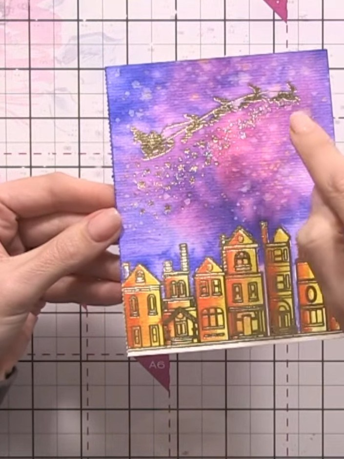 Step 11: Mount the finished painted winter scene onto a card base. The card features the coloured houses at the bottom 
