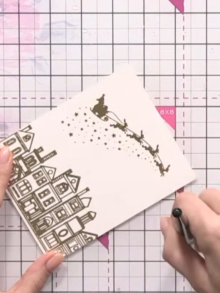 Step 2: Using a clean water brush, carefully paint water around the outlines of the stamped houses to protect them fro