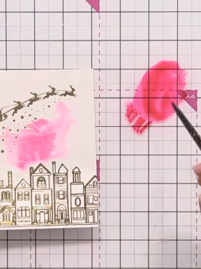 Step 3: Apply pink watercolour to the wet sky area by pouncing your brush. Hold the card at an angle so the colour dis