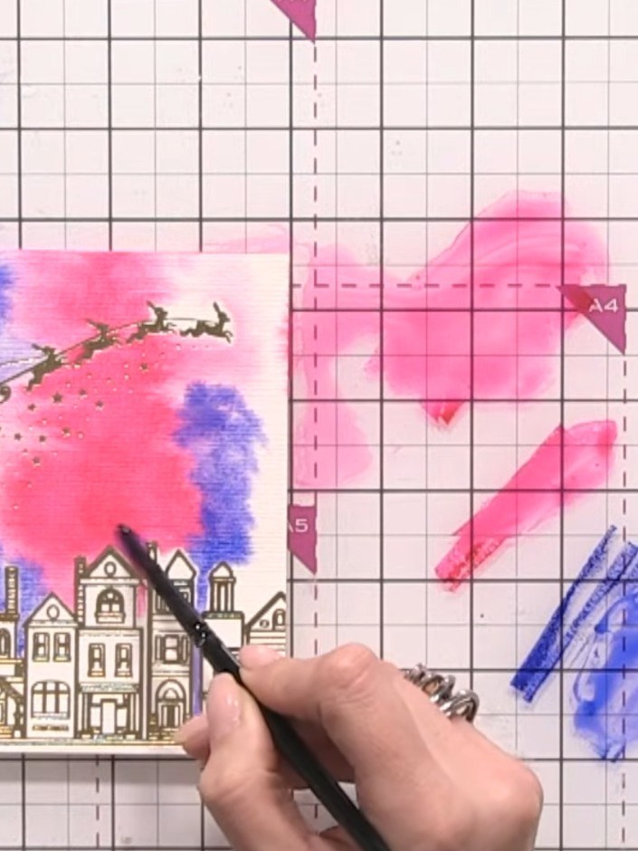 Step 5: Add purple watercolour to the sky area, blending it with the blue. Continue to pounce the brush for even distr