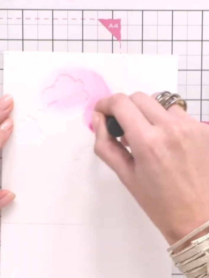 Step 3: Using a spot brush, tap Fandango ink onto the brush. Apply the colour lightly through stencil one onto your wa