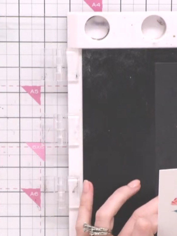 Step 1: Place your A5 watercolour paper onto the craft mat with a black card behind it. Apply the stencil colours one 