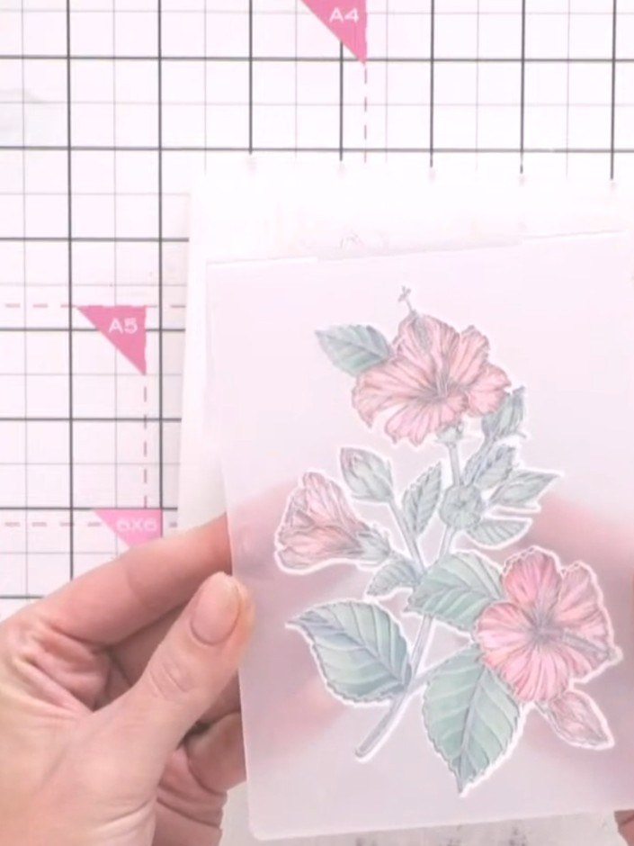 Step 7: Close the embossing folder securely, ensuring the stamped hibiscus design stays in position and does not move 